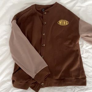 Brown and tan colored varsity fall jacket.